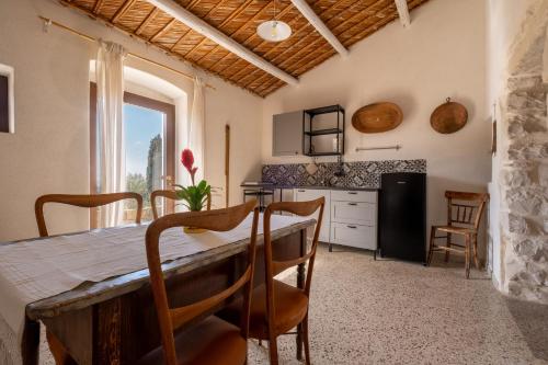 a kitchen and dining room with a table and chairs at Casale Millinchè in Scicli