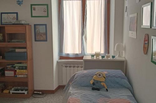a bedroom with a bed with a teddy bear on it at La casa di Raffa in Bonassola