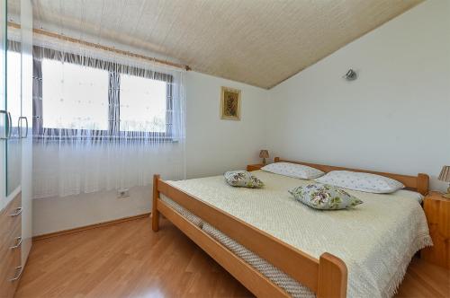 a bedroom with a bed with two pillows on it at Apartments Medulin 2315 in Medulin