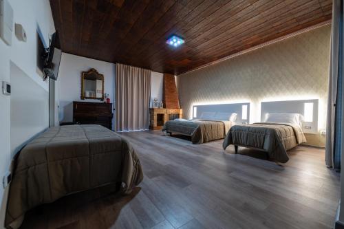 a bedroom with two beds and a mirror at Alta Dimora in Bitritto