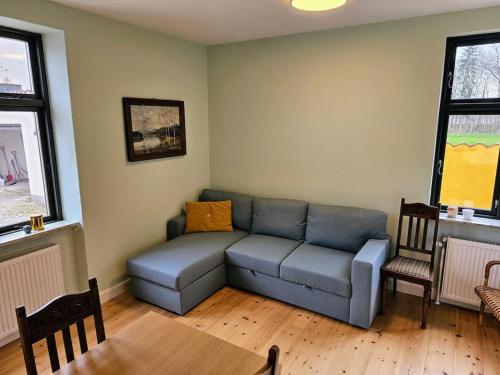 a living room with a couch and a table at Privat lejlighed på landejendommen Frederiks-Eg in Herlufmagle