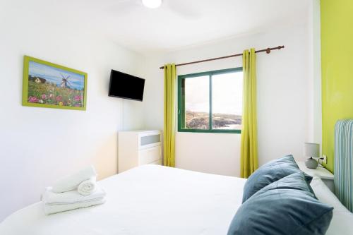 a bedroom with a bed and a window at Nice 2 bd apartment by the sea in Playa San Juan in Playa de San Juan
