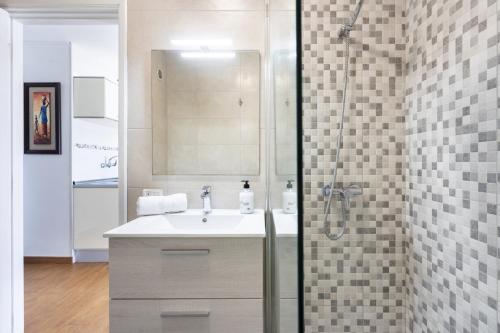 a bathroom with a sink and a shower at Nice 2 bd apartment by the sea in Playa San Juan in Playa de San Juan