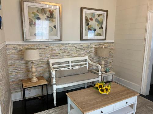 a room with a bed and two tables and two pictures at Downtown Nassau Oasis Unit 2 in Nassau
