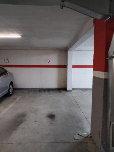 an empty parking garage with a car parked in it at Apartman Centar in Požarevac