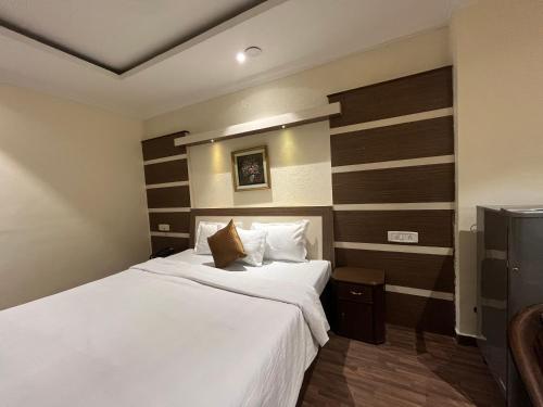 Een bed of bedden in een kamer bij Hotel Vasu International