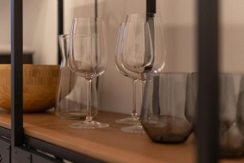 four empty wine glasses sitting on a counter at Dorothea Apartment I levestate in Vienna