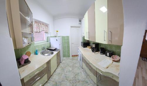 a large bathroom with a sink and a mirror at Smile apartments in Sighişoara