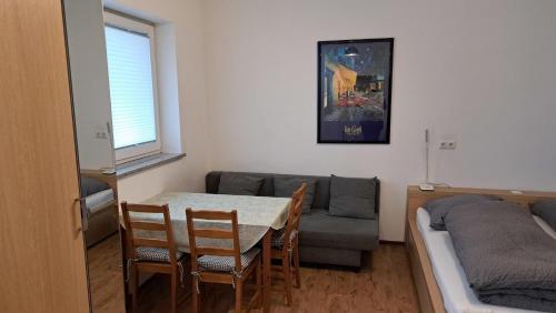 a living room with a table and chairs and a couch at Monte Baldo in Ilmmünster