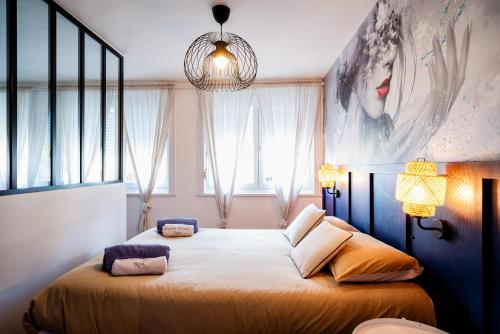 a bedroom with a large bed in front of a window at Sweet Home Spa in Achicourt