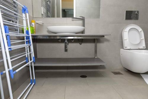 a bathroom with a sink and a toilet at Contemporary apartment at Lemac in Nairobi