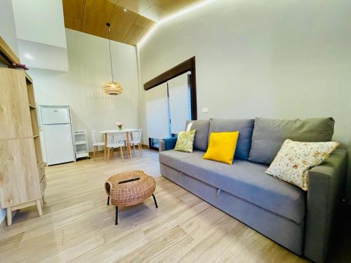 a living room with a blue couch and a table at Las Casitas de Cueva in Cueva