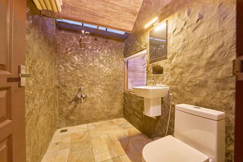 a bathroom with a toilet and a sink at PANCHAVADI FARM STAY in Thekkady