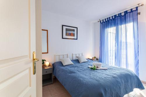 a bedroom with a blue bed and a window at PALAIS DES ARTS AP4399 By Riviera holiday homes in Nice