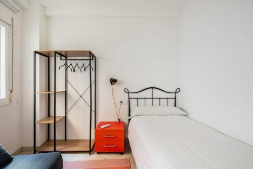 a bedroom with a bed and a red night stand at Iria Gardens in Padrón