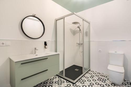 a bathroom with a shower and a sink and a mirror at Iria Gardens in Padrón