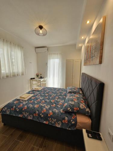 een slaapkamer met een bed met een blauwe deken bij Room Ela in Donji Seget