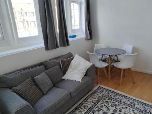 uma sala de estar com um sofá e uma mesa em Flat 1, 106 Belgrave Gate em Leicester