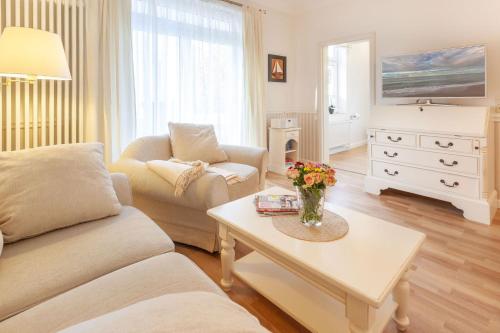 uma sala de estar com um sofá e uma mesa em Villa Granitz Möwennest em Ostseebad Sellin