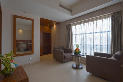 a living room with couches and a large window at Celesta - Kolkata in Kolkata