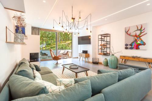 a living room with a blue couch and a table at Villa Baltic Pearl Penthouse in Ostseebad Sellin