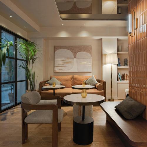 a living room with two tables and a couch at The Residence Aiolou Hotel & Spa in Athens
