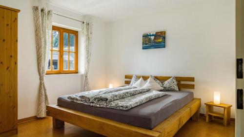 a bedroom with a bed with a wooden bed frame at Schlegelhansenhof in Buchenbach