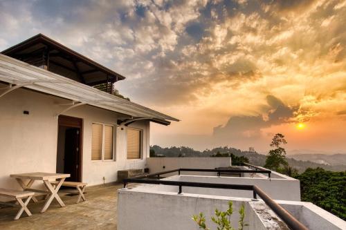a villa with a view of the sunset at Amandara Hills Kandy in Kandy