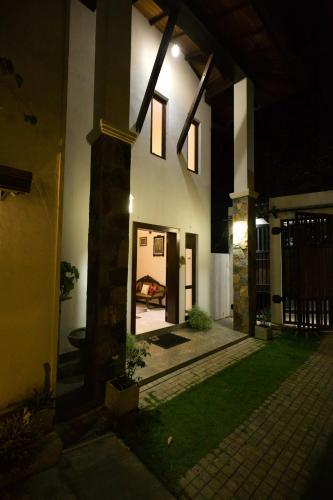 a house at night with the front door open at Amandara Hills Kandy in Kandy