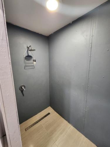 a room with a wall with a bird cage on it at Beach Shed with Pizza Oven in Toogoom
