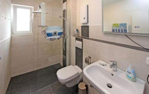 a bathroom with a toilet and a sink at Beautiful Apartment In Graal-mritz ostseehe With Kitchen in Müritz