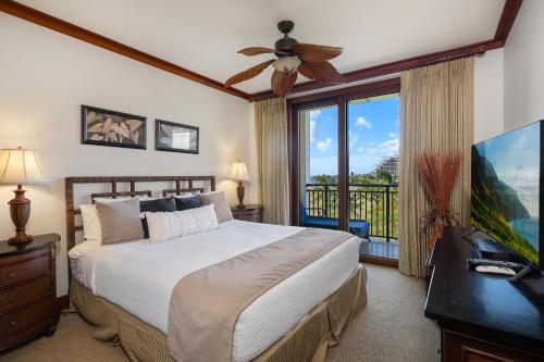a bedroom with a bed and a large window at Ko Olina Beach Villas B506 in Kapolei