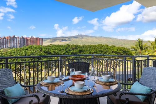 a table on a balcony with a view of a mountain at Ko Olina Beach Villas B506 in Kapolei