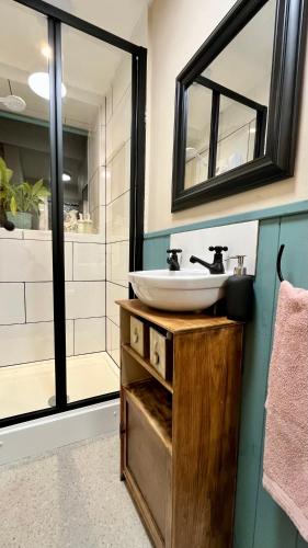 a bathroom with a sink and a mirror at Chapter Cottage, Cheddleton Nr Alton Towers, Peak District, Foxtail Barns, the Ashes in Cheddleton