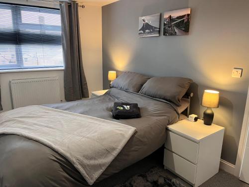 a small bedroom with a bed and a night stand at Meadow Street Rooms in Avonmouth