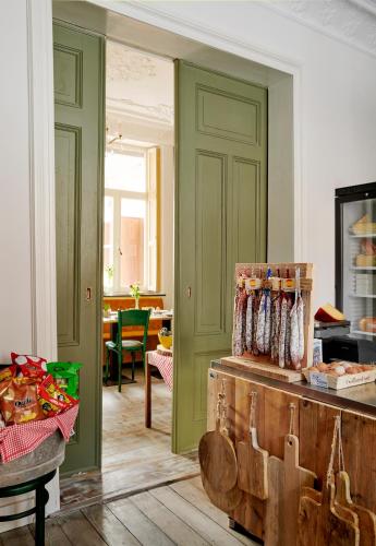 a kitchen with green walls and a table with food at La Dominotte Arcen in Arcen