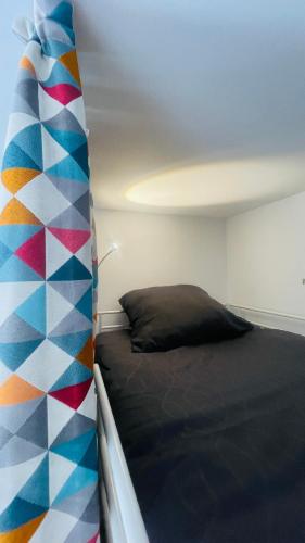 a bedroom with a bed and a colorful wall at « La Cigale » in Peyruis