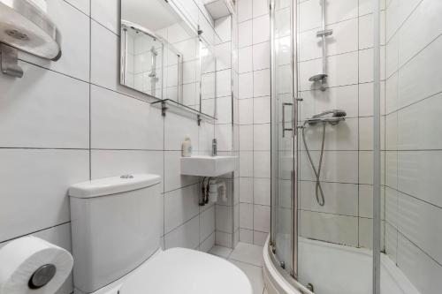 a bathroom with a shower and a toilet and a sink at Wonderful 5 BDR Flat wParking, Maida Vale in London