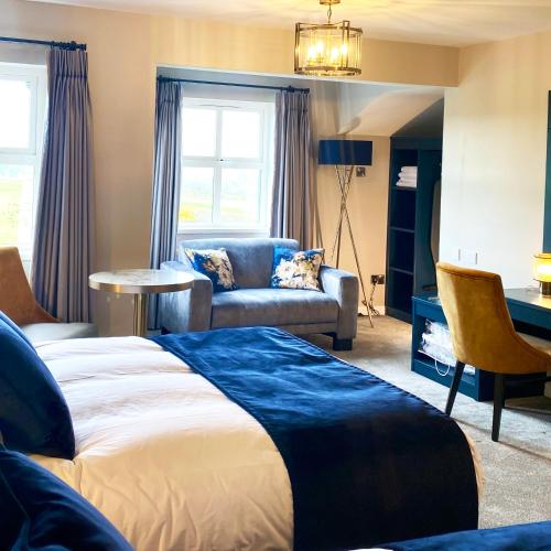 a bedroom with a bed and a couch and a table at Gray's at Bushmills in Bushmills