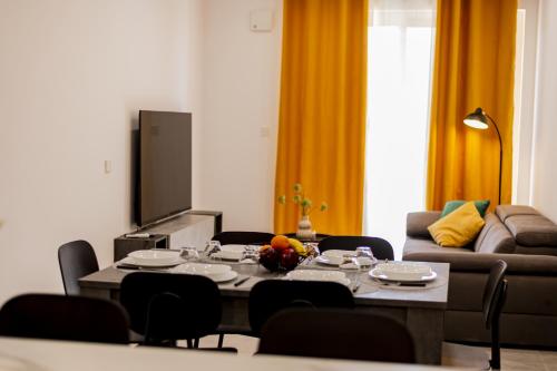 a living room with a table and a couch at Your overseas home in MALTA! in Żabbar