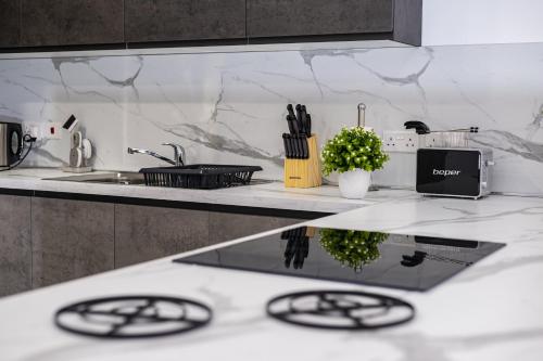 a kitchen with a counter top with a sink and a counter top at Your overseas home in MALTA! in Żabbar