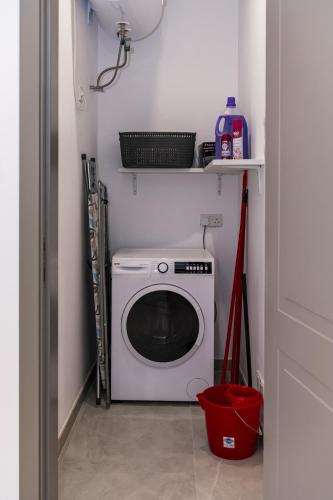 a laundry room with a white washing machine in it at Your overseas home in MALTA! in Żabbar