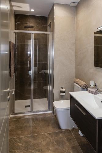 a bathroom with a shower and a toilet and a sink at Your overseas home in MALTA! in Żabbar