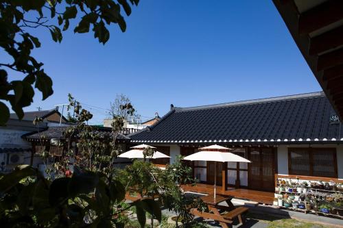 a building with two umbrellas in front of it at Hanok Raon in Gyeongju