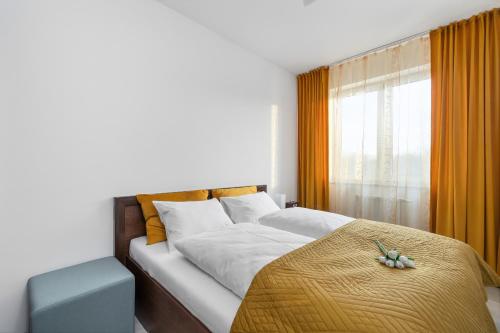 a bedroom with a large bed and a window at Unique Apartment KAMPAT with Balcony for 4 Guests by Renters in Świnoujście