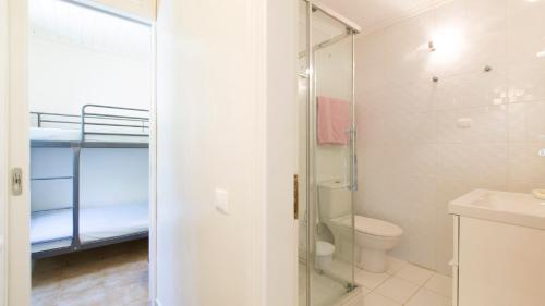 a bathroom with a toilet and a glass shower at Villa Marina in Pelekas
