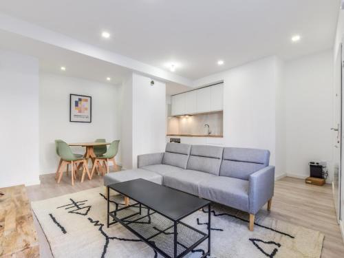 a living room with a couch and a table at apartamentos en madrid rio reformados in Madrid