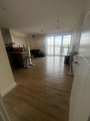 an empty living room with a wooden floor at 2bed flat with the Balcony in Hoo