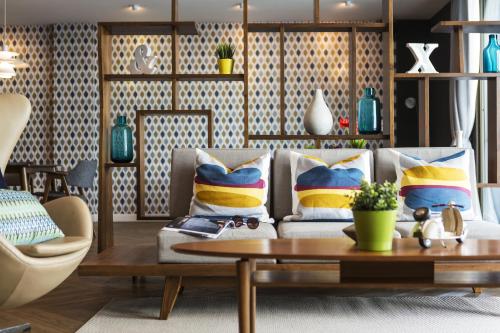 a living room with a couch and a table at Tolani Nimman Villa Chiang Mai in Chiang Mai
