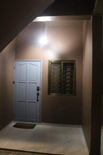 a room with a white door and a window at U APPARTMENTS in Paramaribo